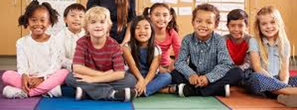 Elementary students sitting on a classroom floor